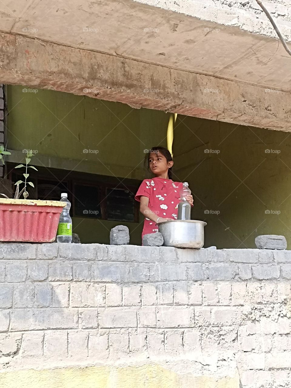 potrate of a beautiful girl who is playing with mud water