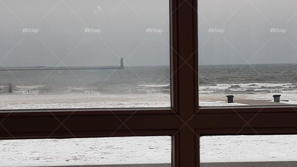 the best view from the window - beach, sea shore, windy cold day, snow and you can be inside and see everything