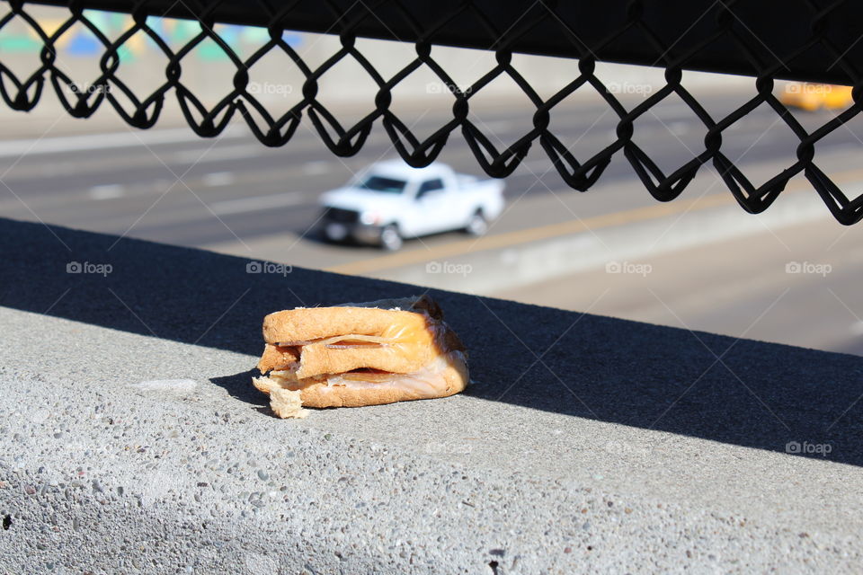 half-eaten sandwich on a overpass