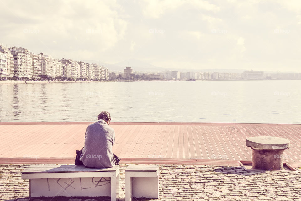 Man Sitting Alone At The Dock And Enjoying The View

