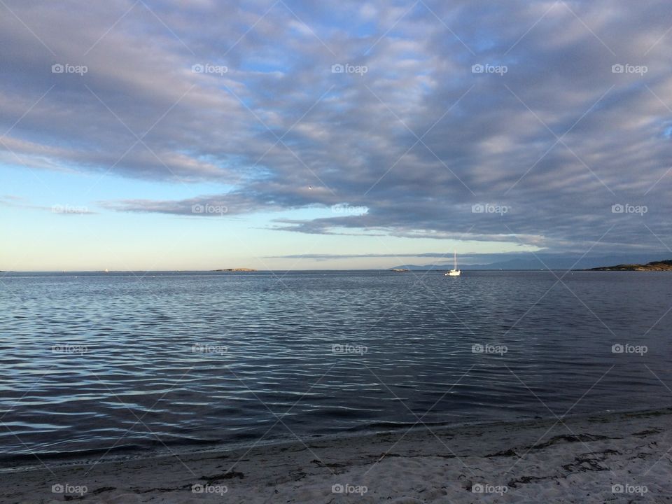 Seascape against cloudy sky