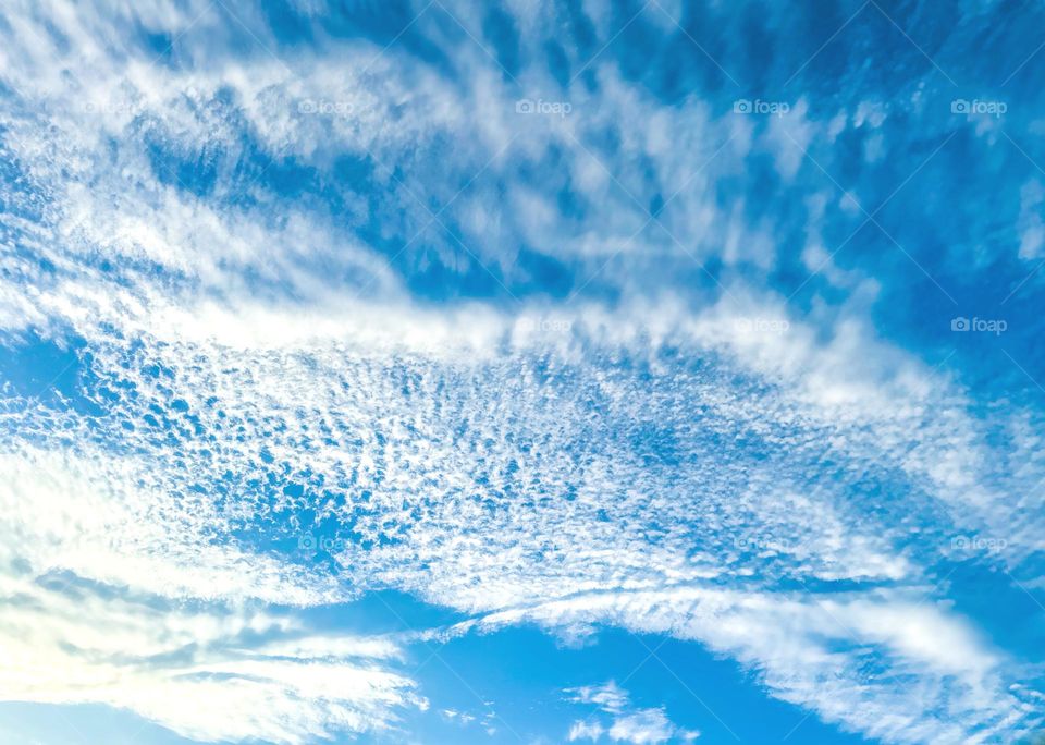 Blue sky and white lacy clouds.