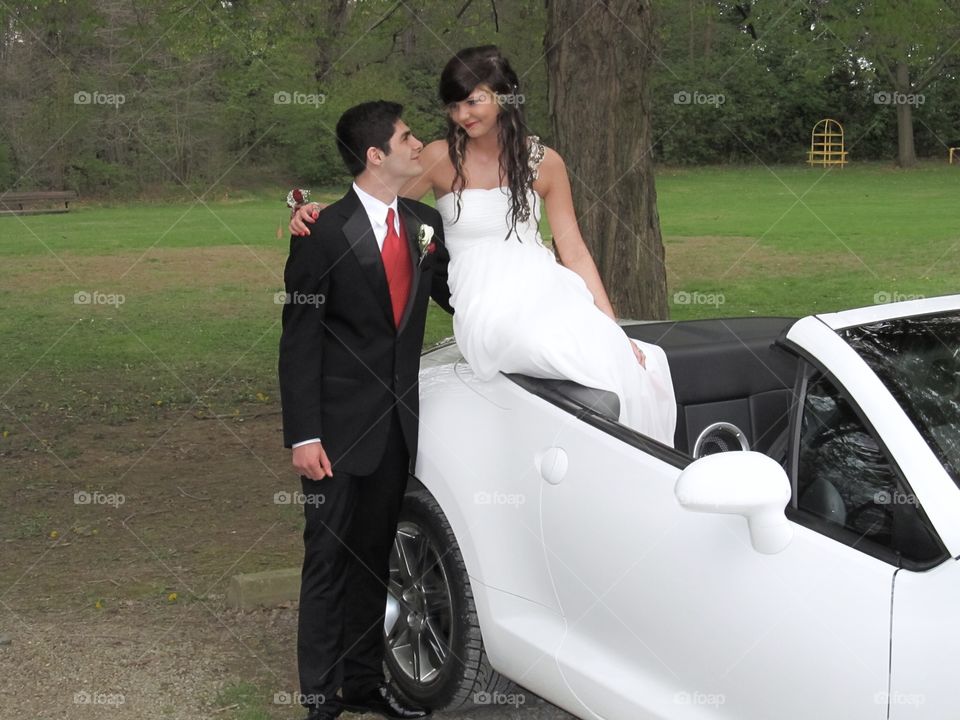 High school prom picture on the back of a white corvette in the middle of the park. I can feel that love through the picture, even though it's long gone in reality.