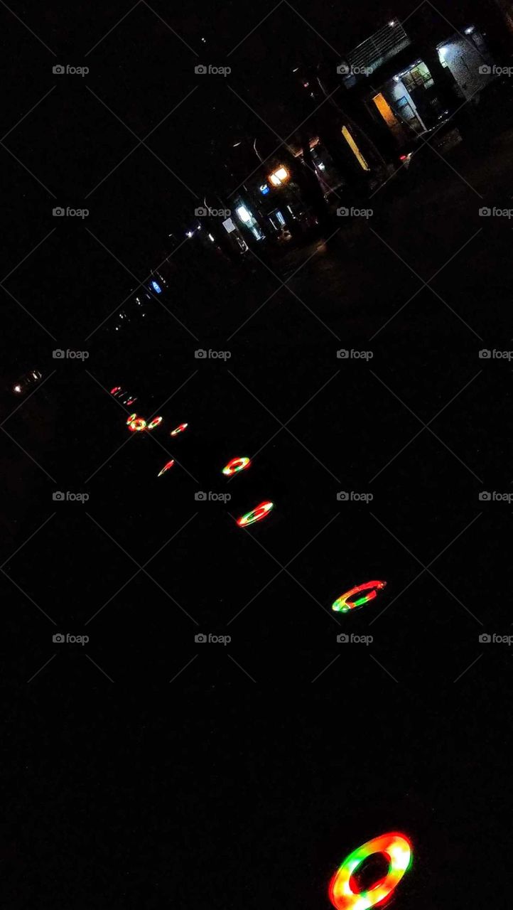 The art of composition: nightscape. roadside lights on the ground are colorful. prominent in the dark.