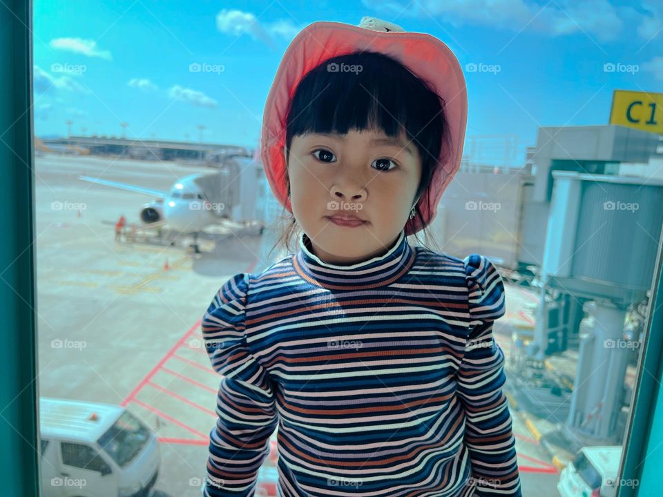 little girl in front of the plane