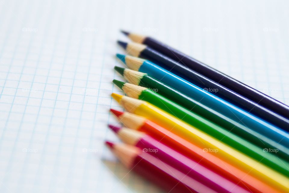 Colored pencils arranged on a graph paper