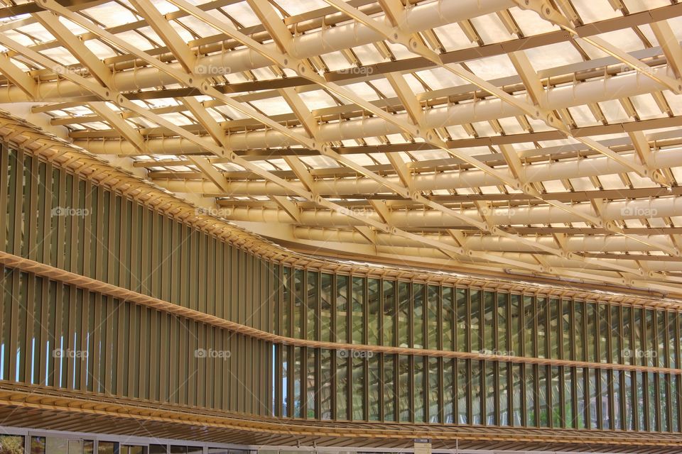 Amazing structural design of the yellow roof of a open air shopping center in Paris.