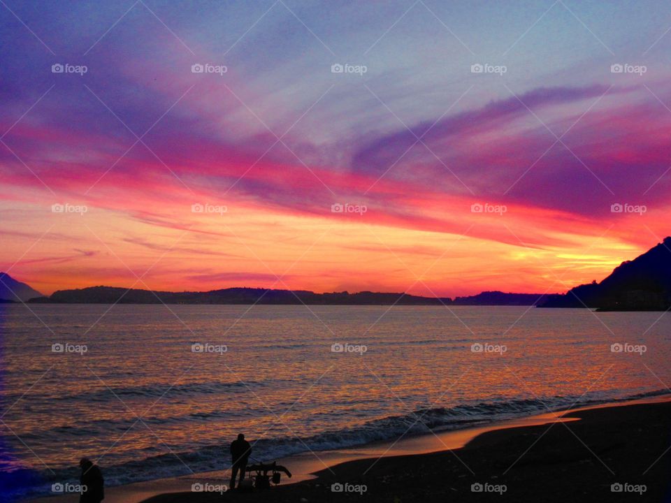 Silhouette of people at beach during sunset