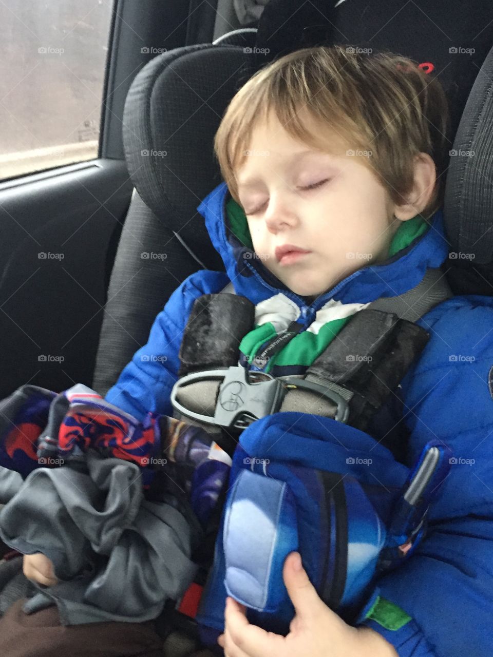 Small child sleeping in car