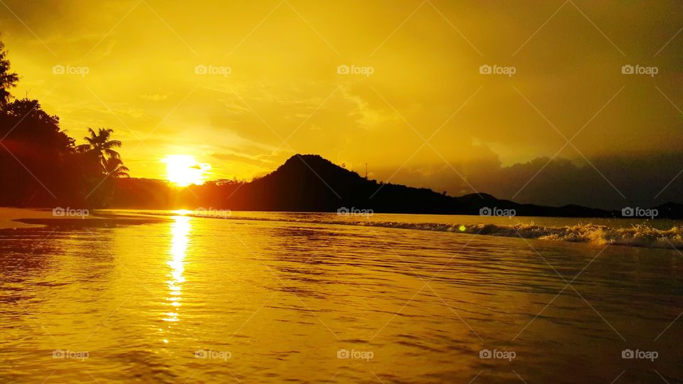 sunset on Seychelles island of Praslin. Cote D'Or red sunlight at the evening