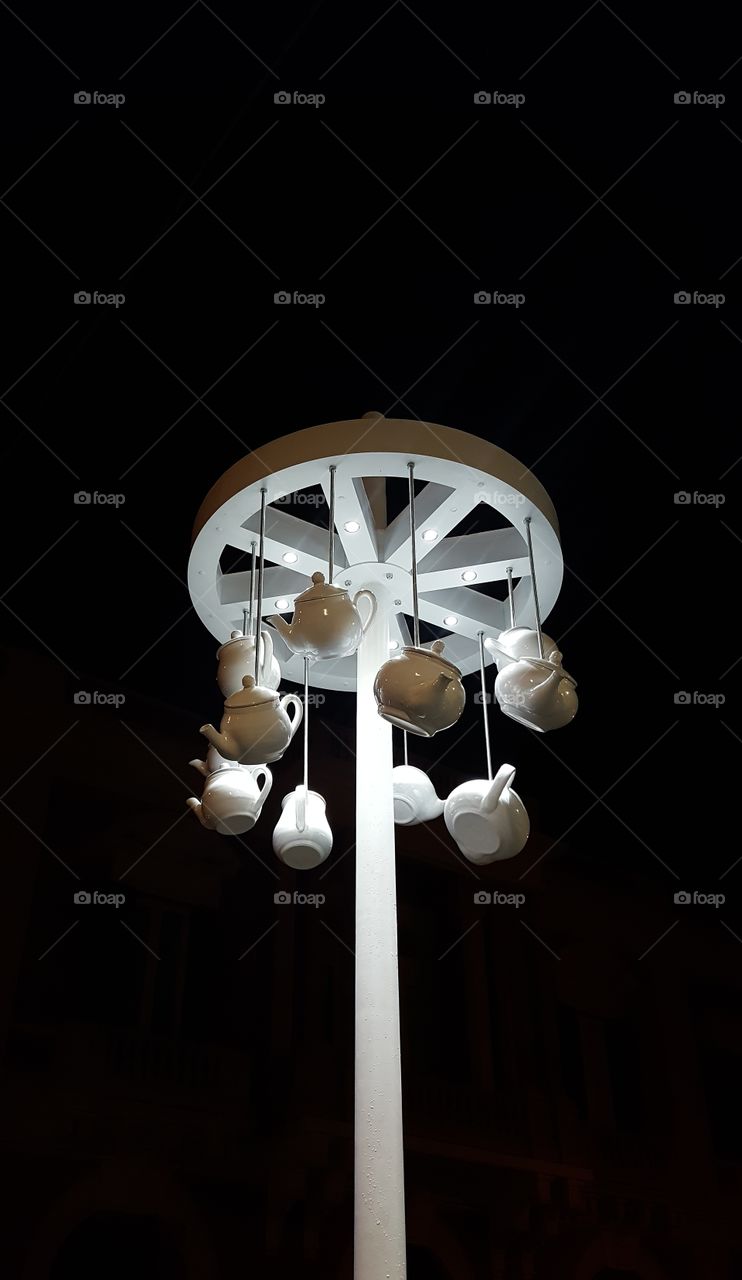lamppost decorated with teapots