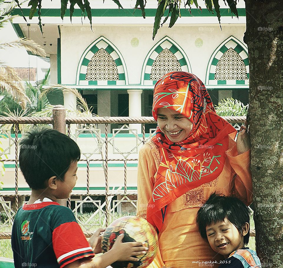 Children playing with their mother