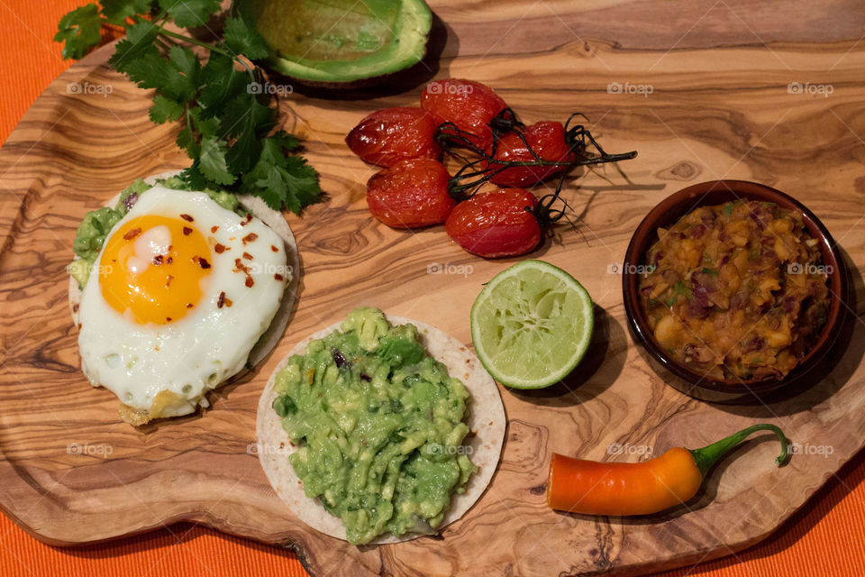 Fried eggs with homemade refried beans and guacamole 