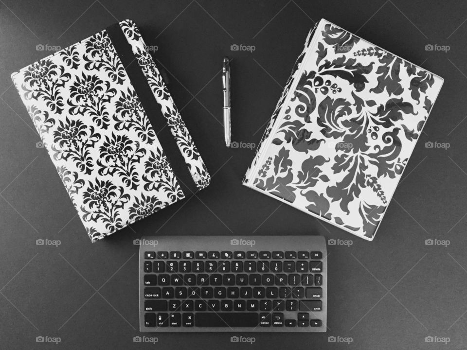 Top view desk - tablet, binder, Bluetooth keyboard, stylus in black and white