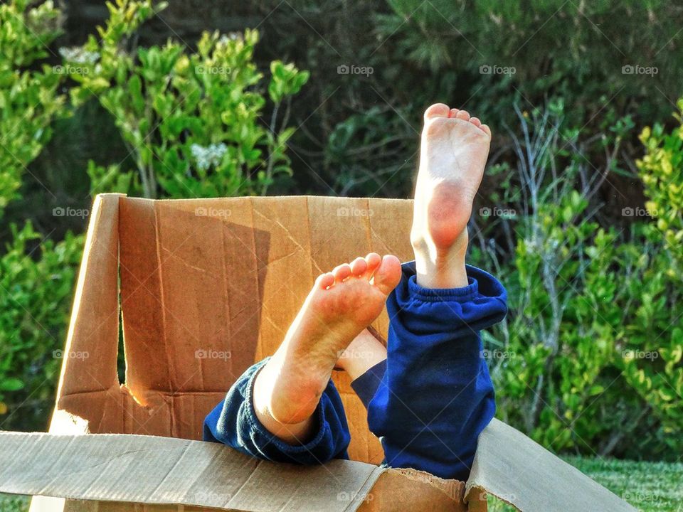 Kid Playing in a Cardboard Box