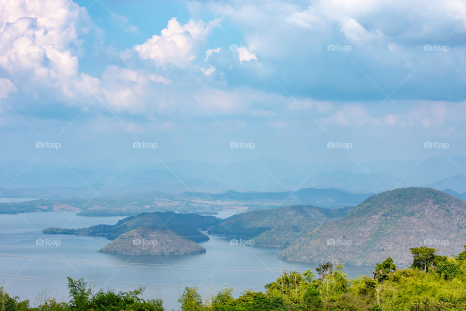 The beauty inside the dam and the houseboat on the bright sky at Sri Nakarin dam , Kanchana buri in Thailand.