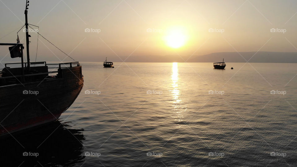 Boats anchored on the coast of the Sea of Galilee in Israel.