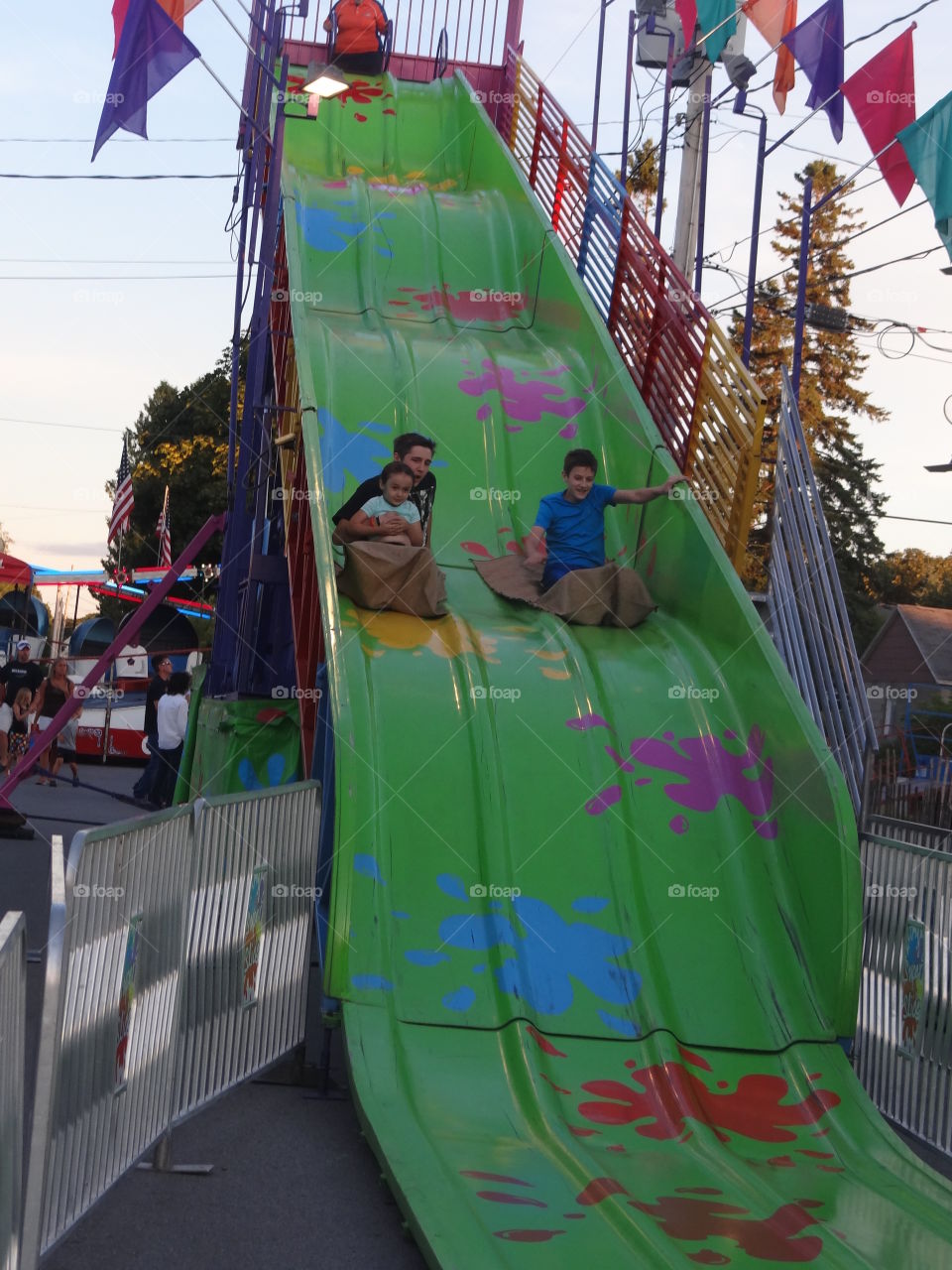 Super Slide. Kids having a blast on a super slide at a summer fair