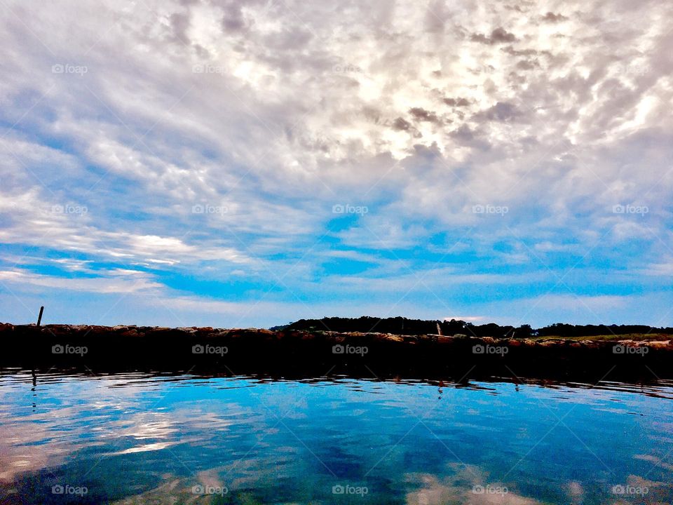 A gorgeous sunset picture taken while underway on the waters of the East River with the sailboat “Salvation”. A dramatic cloud pattern is overhead. 2019. Hypnotic Productions