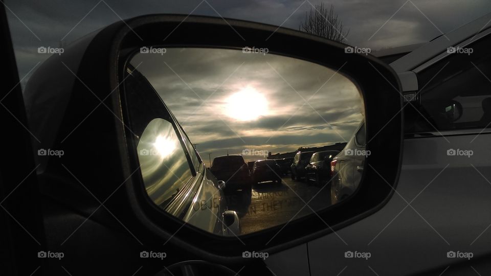Afternoon sun reflecting in the side view mirror