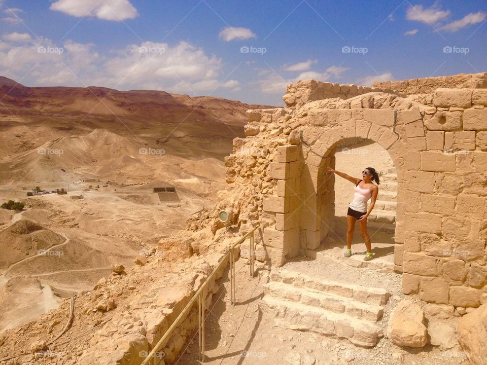 Girl pointing in desert