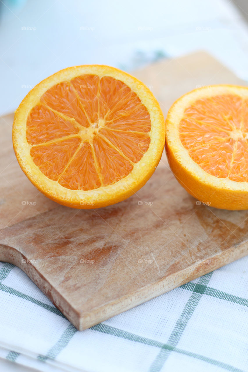 Halved orange on cutting board