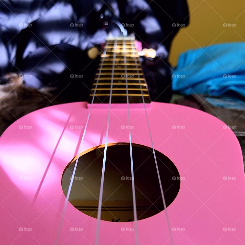 Close-up of pink shiny guitar