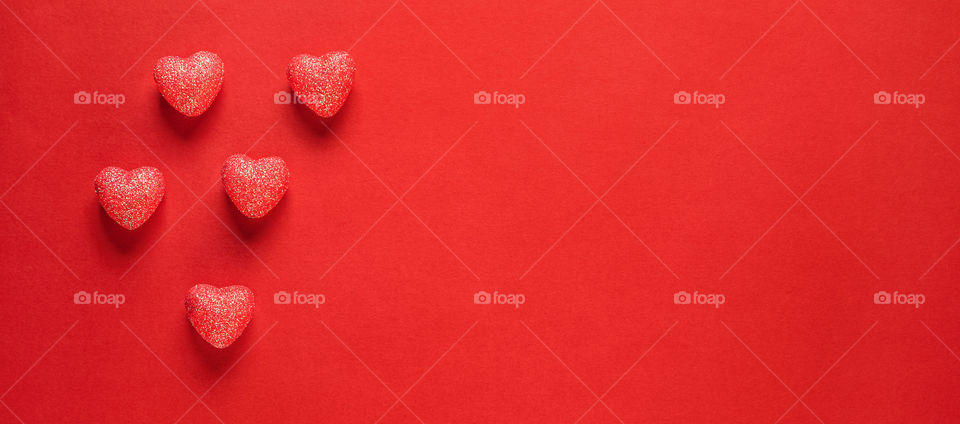 Postcard. Red hearts on a red background. Valentine's Day.