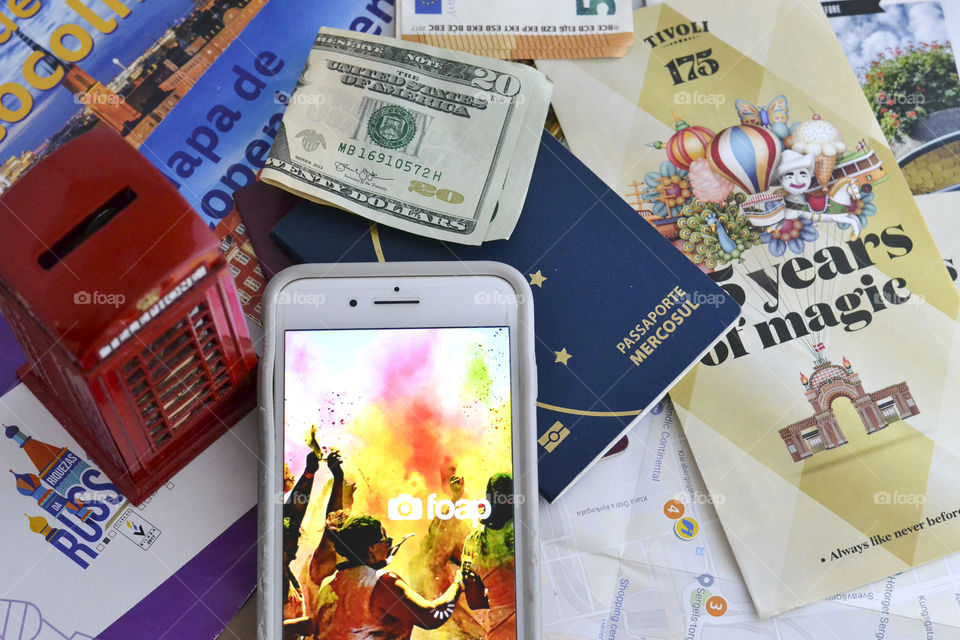 A cell phone with Foap  app ,some passports ,dollars and travel prospects 