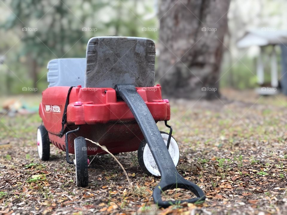 Forgotten childrens old red wagon left outside 