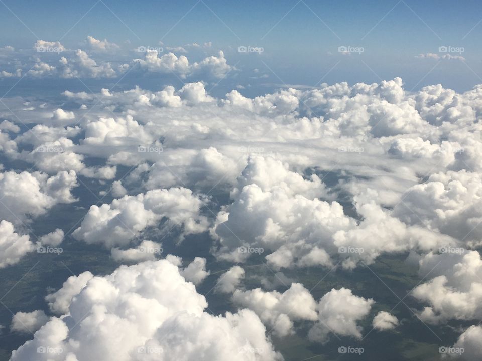 Aerial view of white fluffy clouds from above 