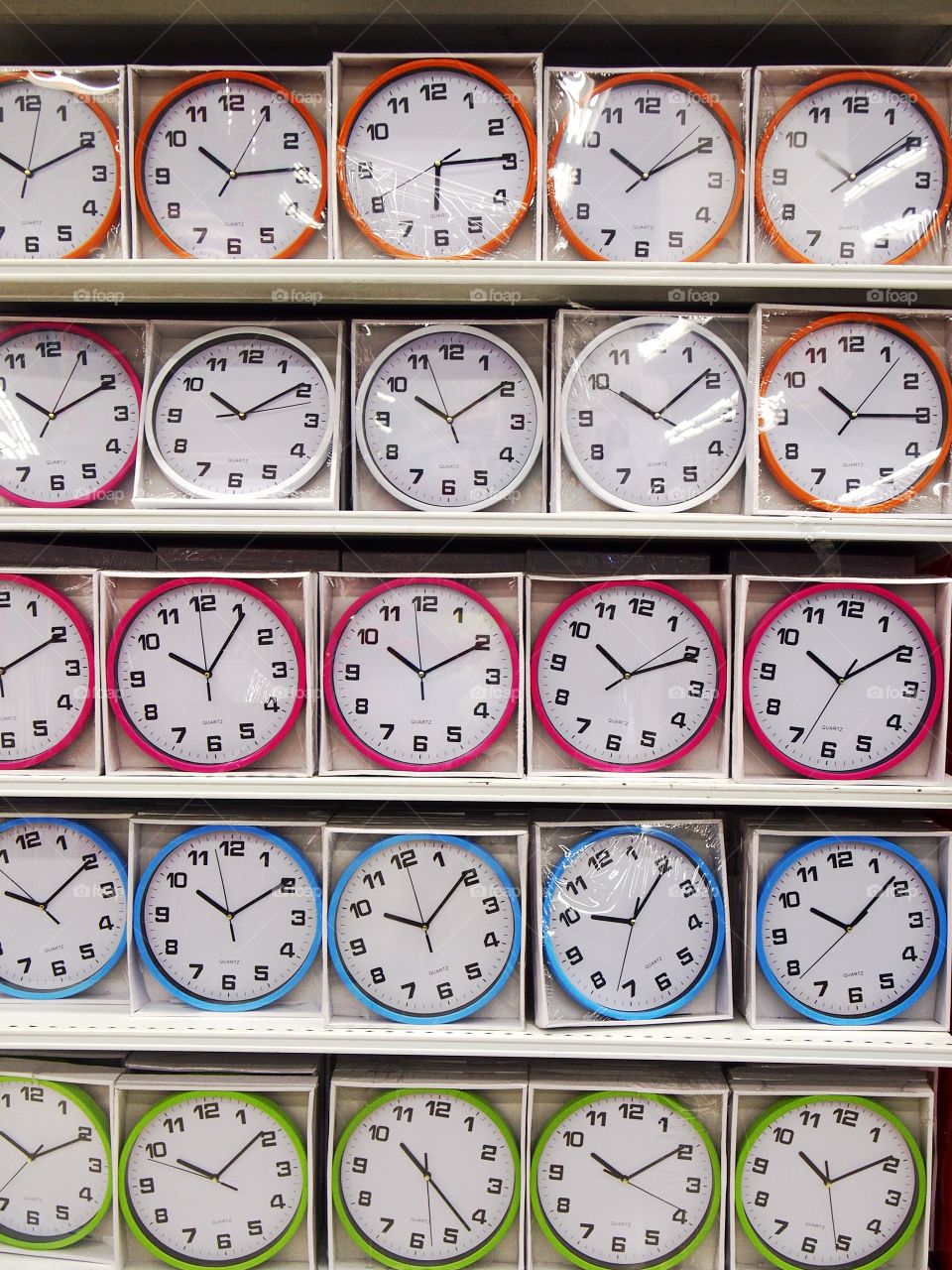 colored wall clocks on display at a store