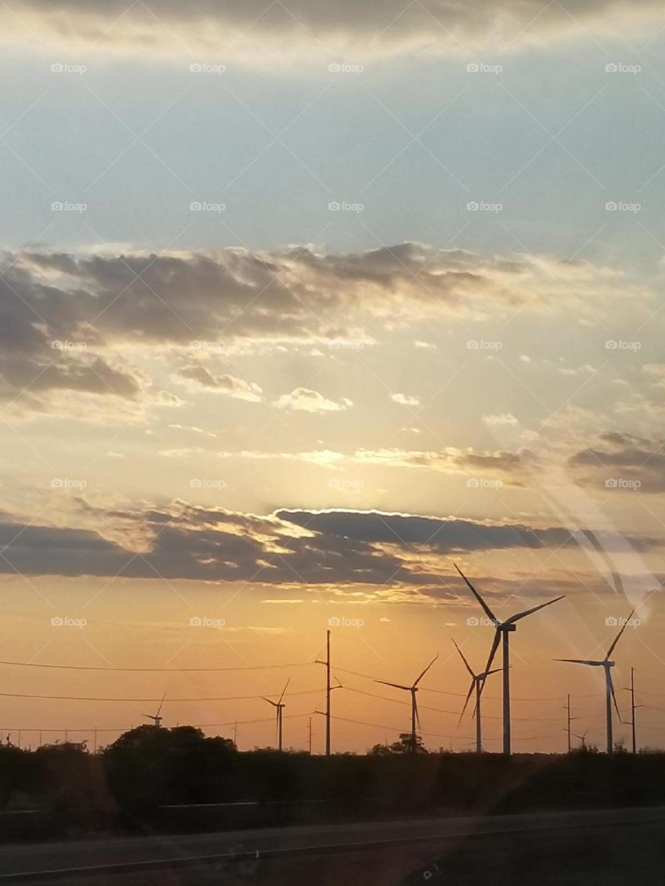 wind mills turning in the setting sun
