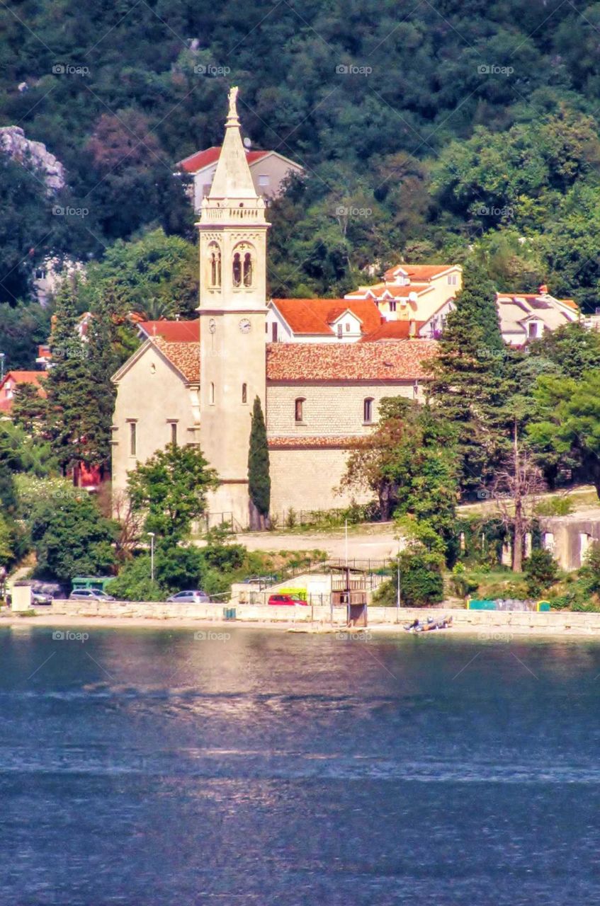 A village featuring a belltower along the Adriatic Sea near Croatia