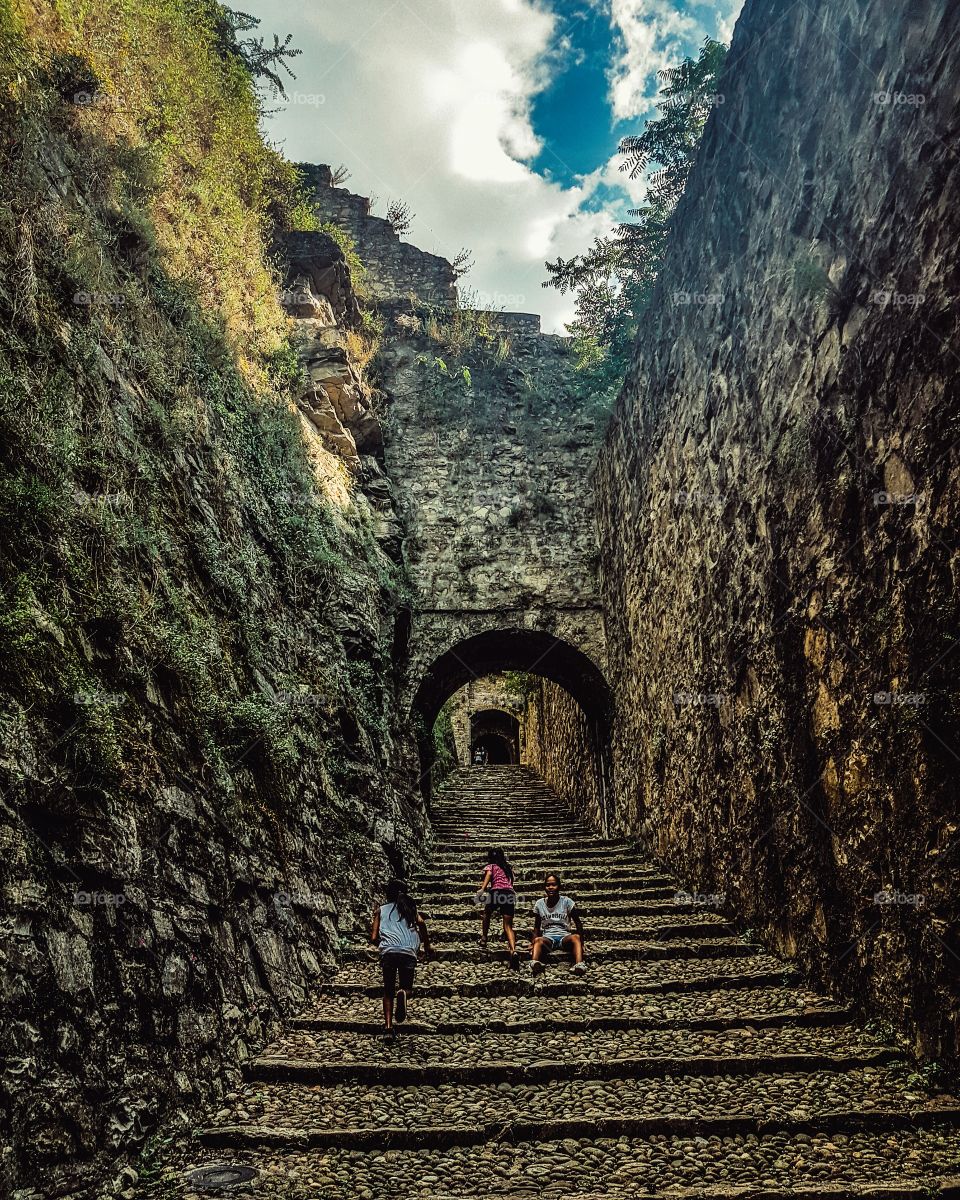 Small group of girls walking on the fort staircase