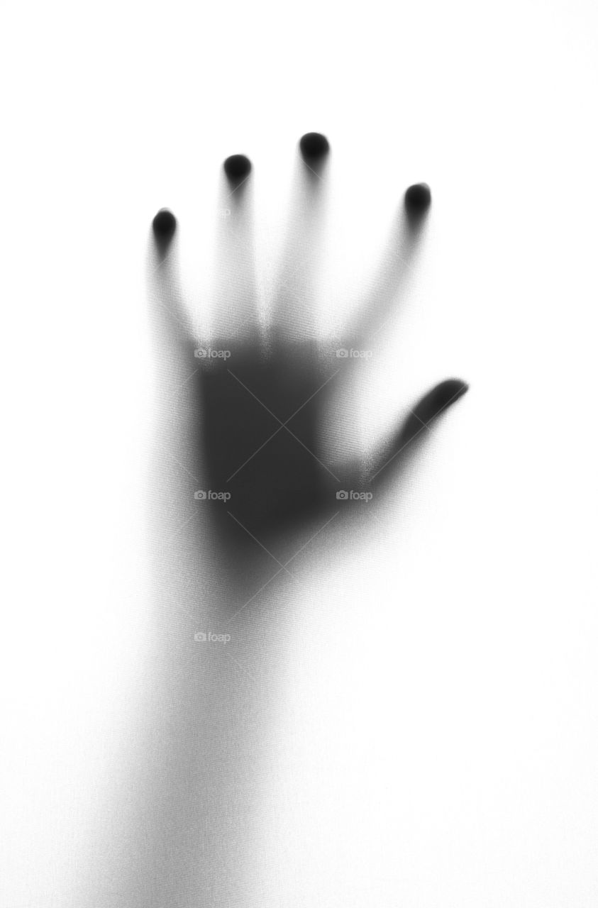 Horror concept. Hand on a bathroom glass door or window