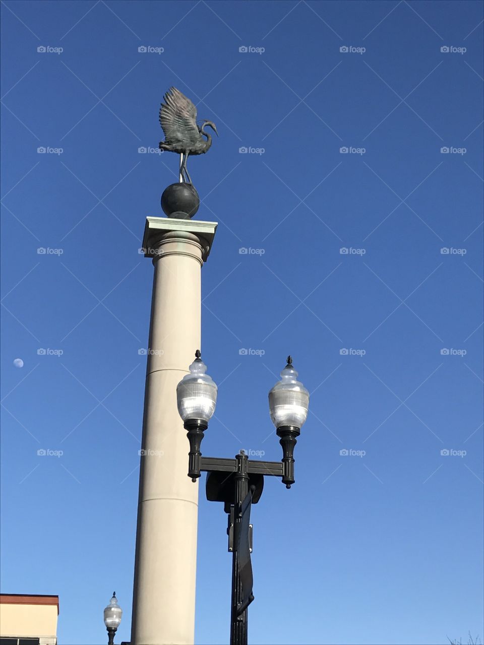 Pillar with crane statue