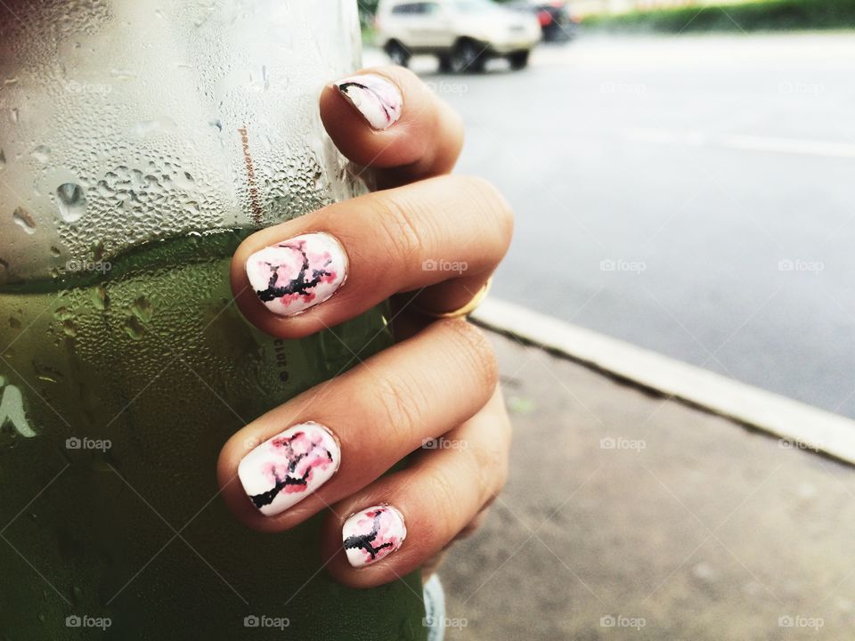 Cherry Blossom Nail Art. . Cherry blossom trees on nails, holding green tea. 