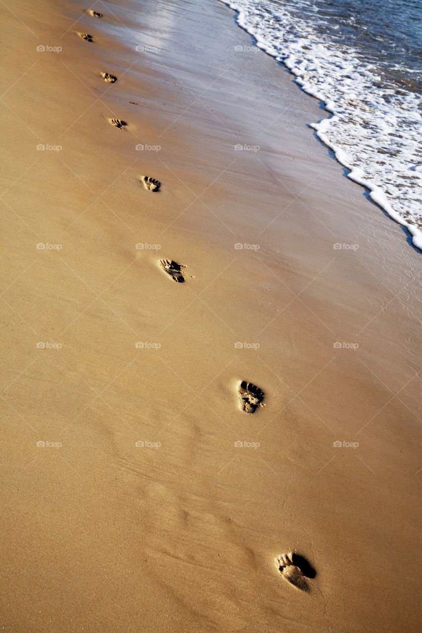 High angle view of footprints on beach