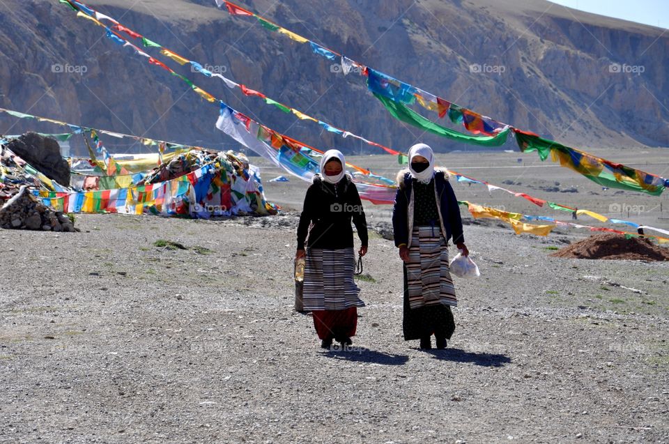 Tibetan women in traditional clothes at the lakeside 