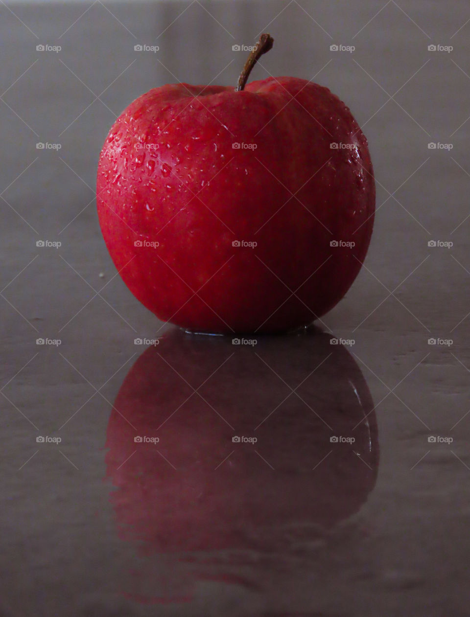 Apple reflecting off the kitchen table.