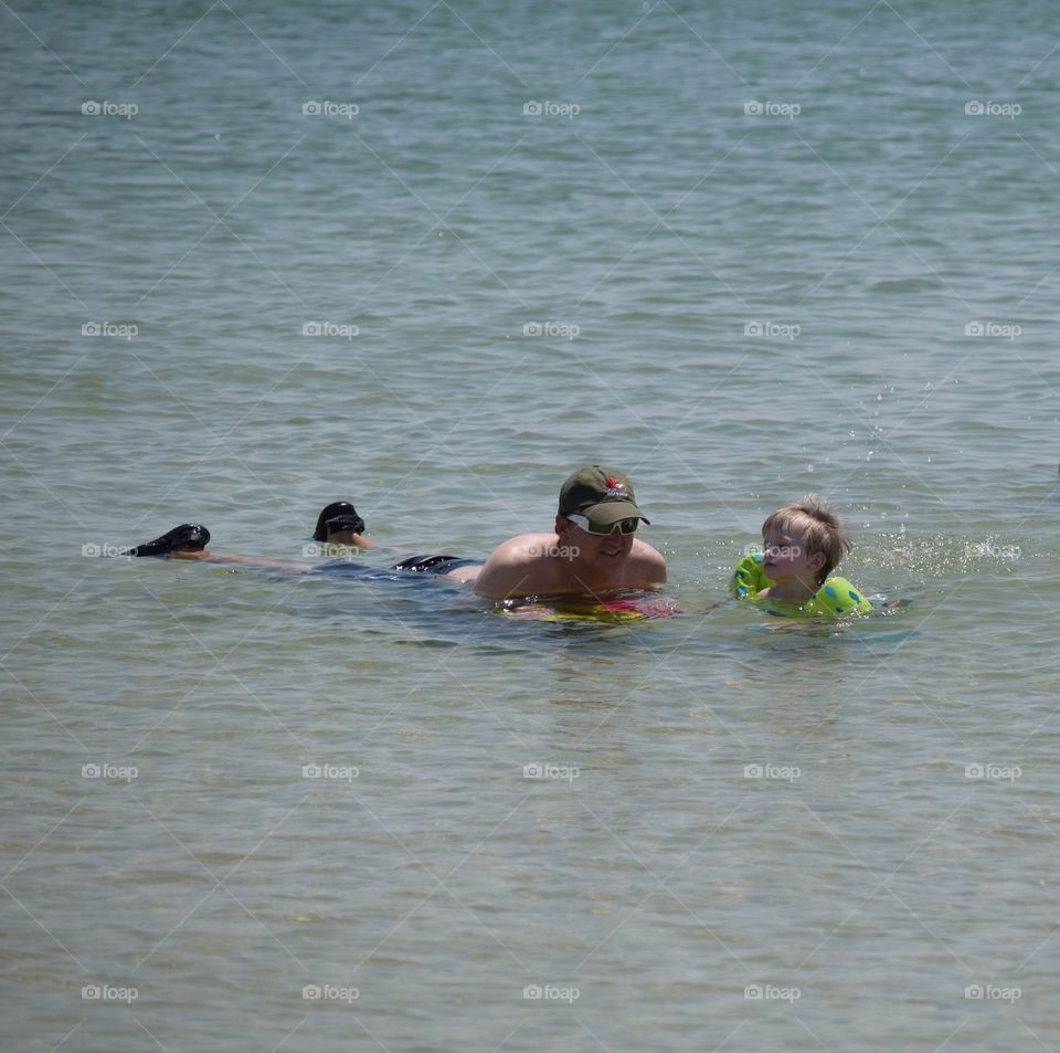 Father and son swimming in the ocean