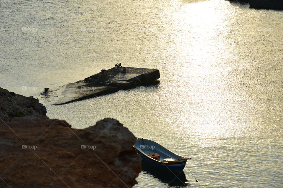 Women taking selfies at sunset by the sea