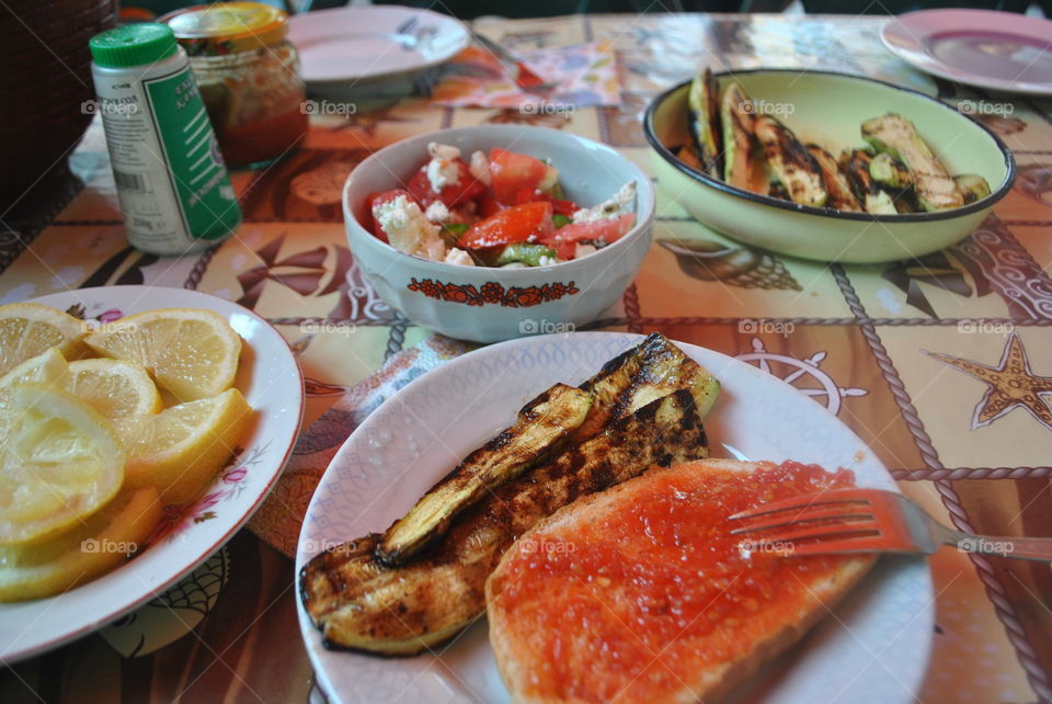 Bulgarian dinner at home salad, zucchini, lemons, bread