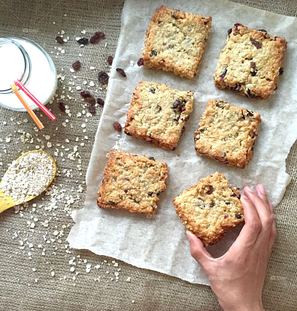 Person's hand holding fresh cookie