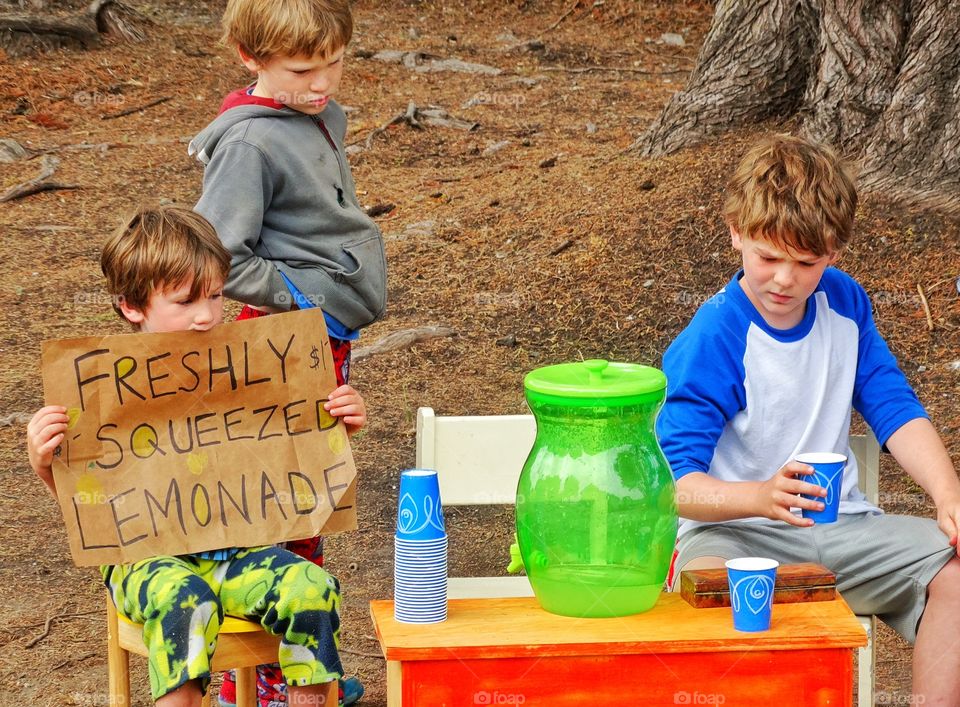 Adorable children with lemonade at park