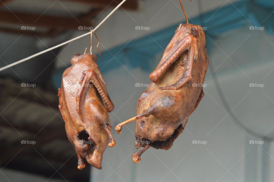 smoked chicken or duck hanging on a rope meat product natural