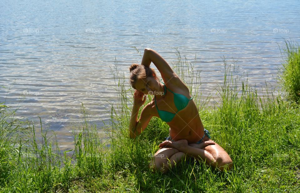 girl training yoga on a lake shore summer time, yoga outdoor