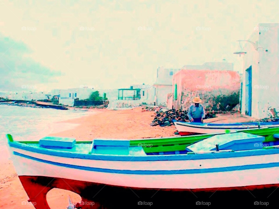 A lonely man working at his boat