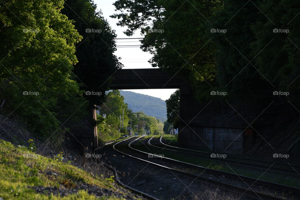 train track bridge with mountain view
